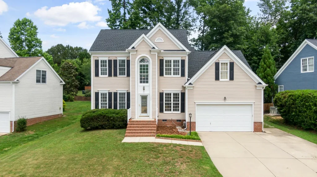 Two-story colonial home with refreshed siding and shutters
