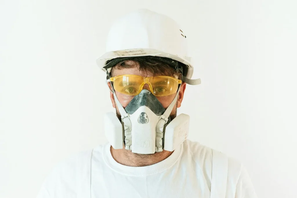 Worker in protective gear and respirator for asbestos abatement