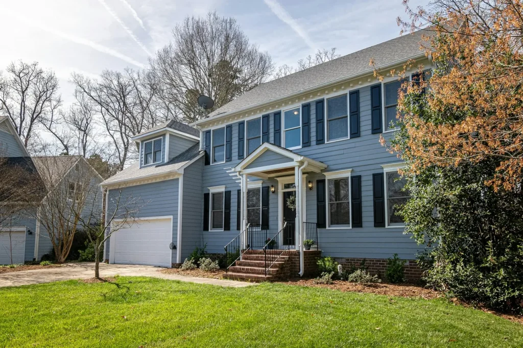 Two-story home with newly installed siding and white trim