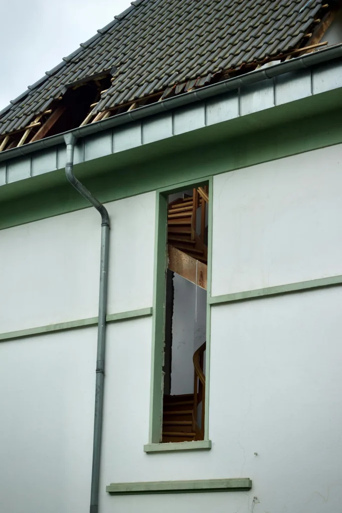 Residential roof and siding damaged by a storm